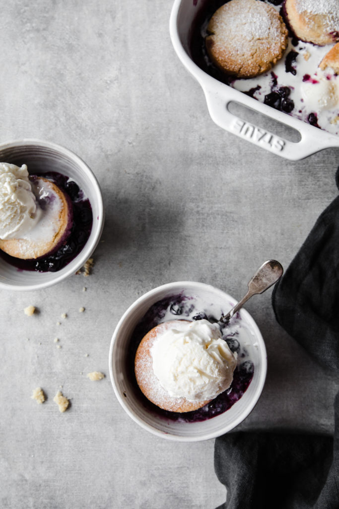 overhead white bowls with keto blueberry cobbler