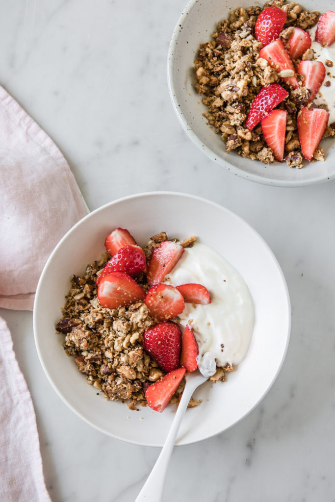 keto granola in bowl with strawberries