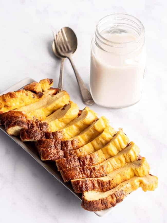 slices of egg loaf on a white background with a glass of milk